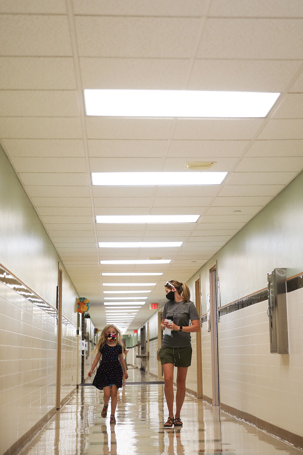 Jessica Kavitz walks down the hall to the office with student Ayla Puente